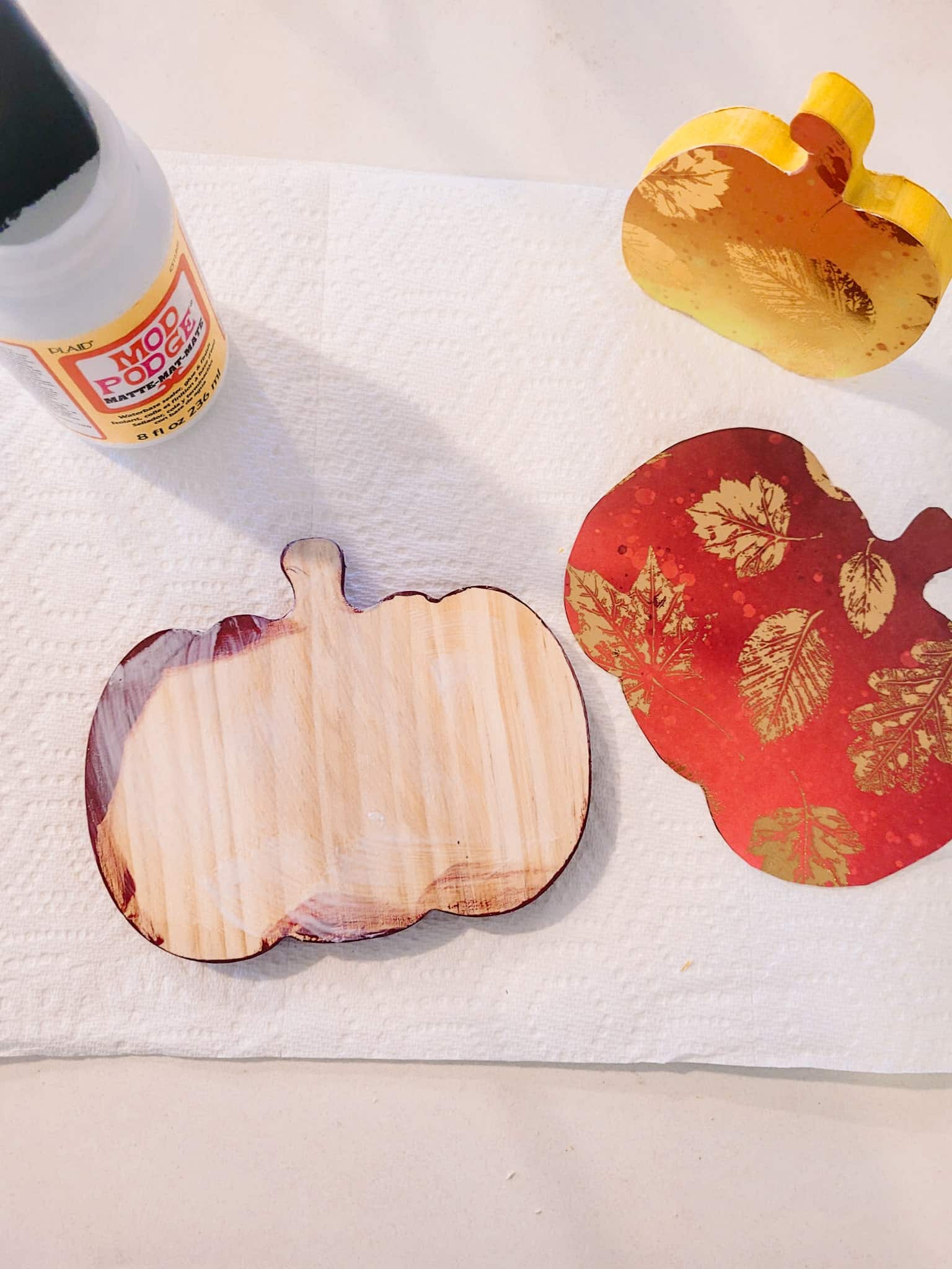 glue scrapbook paper to the pumpkins