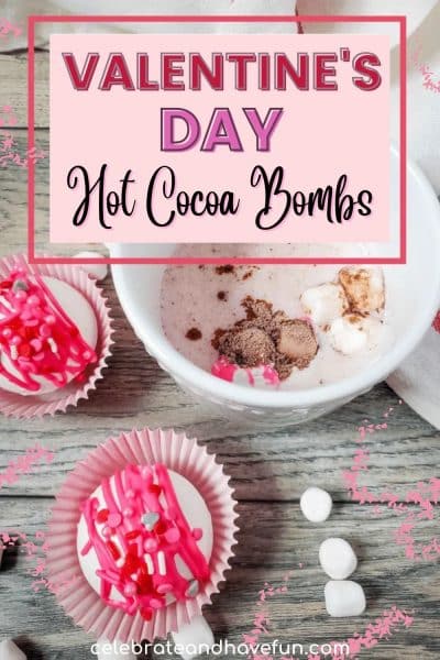 hot chocolate bombs in valentine's day wrappers on a table with a mug of hot chocolate