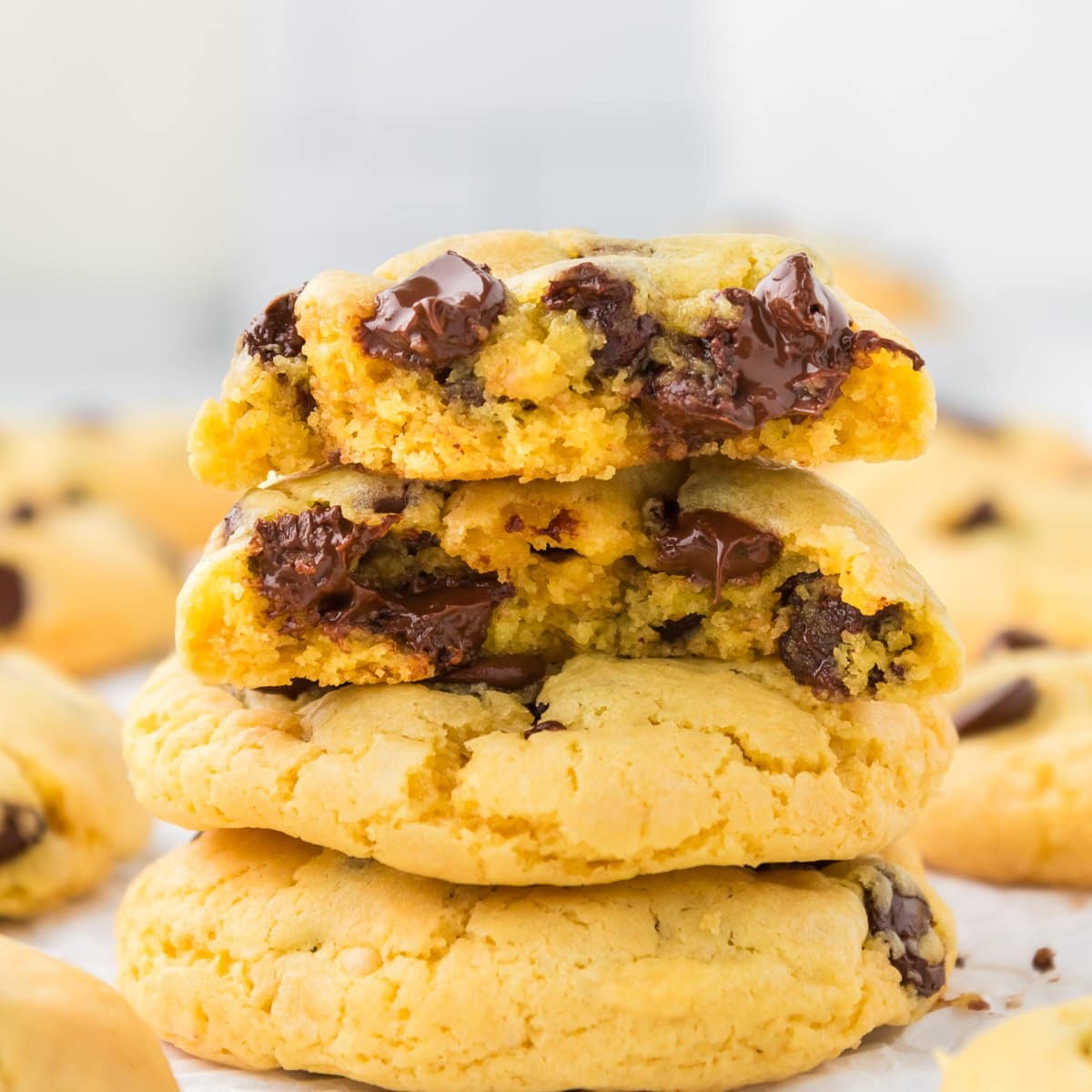 yellow cake mix cookies stacked on top of each other with gooey chocolate chips